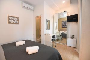 a bedroom with a bed and a desk and a mirror at Il Padrino Rooms in Zadar