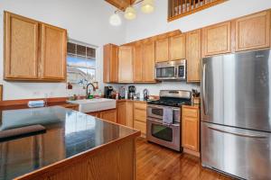 a kitchen with wooden cabinets and a stainless steel refrigerator at Beautiful home in Beach Park IL in Beach Park