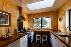 a kitchen with wooden walls and a skylight at Fiery Peak Eco-Retreat in Geraldine