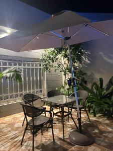 a table and chairs with an umbrella on a patio at Valley Villa in Jeddah