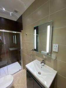 a bathroom with a sink and a shower and a toilet at Luxury Apartment APT3 in Wolverhampton