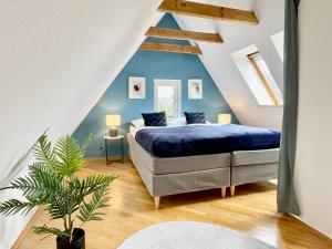 a bedroom with a bed in a attic at Design Maisonette I Kamin I 10 Personen I Netflix in Bremen