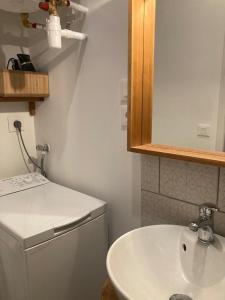a bathroom with a white sink and a mirror at studio-ville médievale-charmant in Crest +16 photos