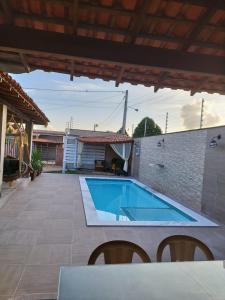 a swimming pool on the patio of a house at CASA TEMPORADA Barreirinhas in Barreirinhas