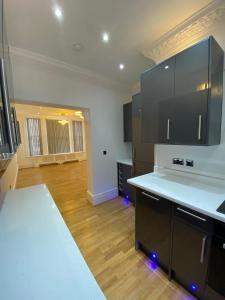 a kitchen with a white counter top in a room at Luxury Apartment with a jacuzzi in Wolverhampton