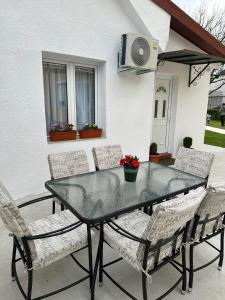 a table and chairs on a patio at Apartman Emily in Nikšić