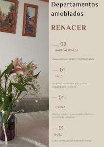 a table with a vase of flowers and pictures at Renacer apartamentos in Tacna