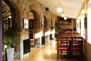 a restaurant with a row of tables and chairs at The Angel View Hotel in Gateshead