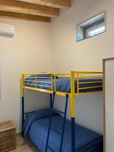 a bedroom with two bunk beds in a room at Villa Andrea in Fondachello