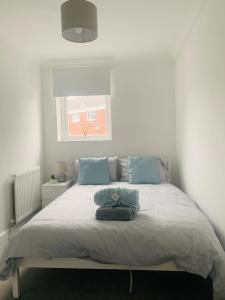 a bedroom with a bed with a bag on it at Greenshaw 3 Bedroom Terrace in Brentwood