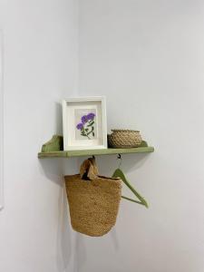 a shelf with a picture and a basket on a wall at Bodega Sibeiro in Chantada