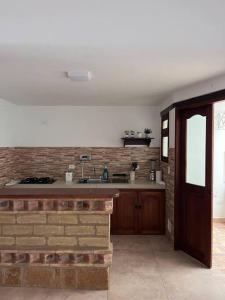 een keuken met een bakstenen muur en een aanrecht bij Apartamento en Villa de Leyva in Villa de Leyva