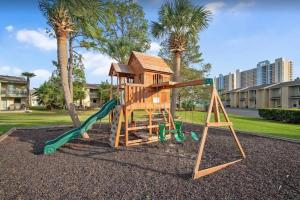 a playground with a slide and a playset at Sandcastles and Sunshine - Gulf Highlands Beach Resort in Panama City Beach