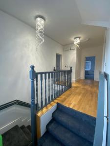 een trap in een huis met een licht aan het plafond bij Penthouse APT8 in Wolverhampton