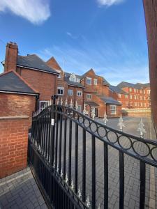 a black fence in front of a street with houses at Penthouse APT8 in Wolverhampton