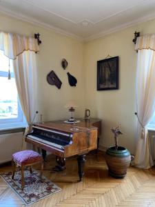 a living room with a piano and a table at The Marchburg Apartment in Maribor