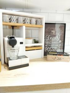 a kitchen with white cabinets and a chalkboard sign at Natural Charm Apartment in Rome