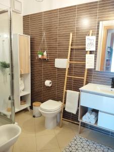 a bathroom with a toilet and a sink at Natural Charm Apartment in Rome