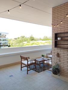 a patio with two tables and chairs and a window at Natural Charm Apartment in Rome