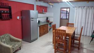 a kitchen with a refrigerator and a table and chairs at Lo de la Abuela in Goya