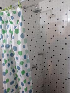a bathroom with a shower with polka dot shower curtains at Hotel Bogotá Calle 100 in Bogotá