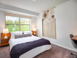 a bedroom with a large bed and a window at Hyatus at City Views in Bethlehem