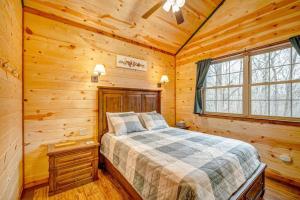 a bedroom with a bed in a log cabin at Greenbrier Beechhouse Luxury Treehouse in Greenbrier