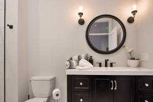 a bathroom with a sink and a mirror at The National on Queen in Saint Marys