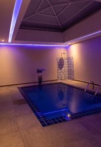 a swimming pool with blue lights in a room at Motel Tenda in Seabra