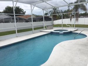 a swimming pool with blue water in a building at Florida Escape in Orlando +4 photos