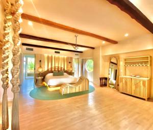 a large bedroom with a bed and a couch at Hotel Shibari - Restaurant & Cenote Club in Tulum