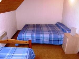 a small bedroom with a bed and a chair at Appartement Esquièze-Sère, 3 pièces, 7 personnes - FR-1-402-87 in Esquièze - Sère