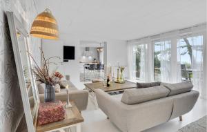 a living room with a couch and a table at Beach Front Home In Slagelse With Kitchen in Lille Kongsmark