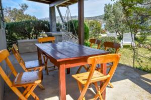 a wooden table and chairs on a patio at House Zora in Otok Zizanj