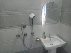 a bathroom with a shower and a sink at Gujrada Peaks home stay in Narendranagar