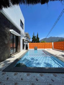 a swimming pool in the backyard of a house at Villa Qfa Syariah in Lembang