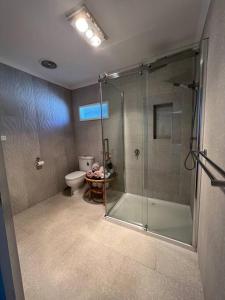 a bathroom with a shower and a toilet at Cosy Eildon Getaway in Eildon