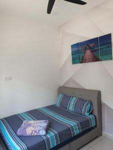 uma cama num quarto com uma fotografia na parede em Sekinchan29homestay em Sekincan
