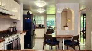 a kitchen with a table and a black refrigerator at Casa Tamayo in Mexico City