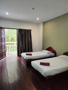 Katil atau katil-katil dalam bilik di Fairy Garden Resort Kundasang