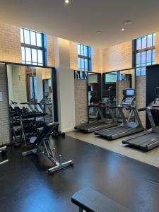 a gym with rows of treadmills and elliptical machines at Beautiful one bedroom downtown Condo with pool and free parking in Montreal
