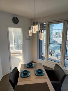 a dining room with a table and chairs and a clock at Beautiful one bedroom downtown Condo with pool and free parking in Montreal