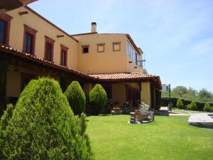 a house with a green yard in front of it at Mirador del Frayle in San Miguel de Allende
