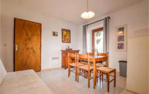 a dining room with a table and chairs at Lovely Apartment In Carcheto Brustico With Outdoor Swimming Pool in Carcheto