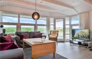 a living room with a couch and a tv at Stunning Home In Hvide Sande With Wifi in Bjerregård
