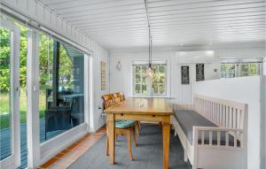 a dining room with a wooden table and chairs at Stunning Home In Blvand With 3 Bedrooms, Sauna And Wifi in Blåvand