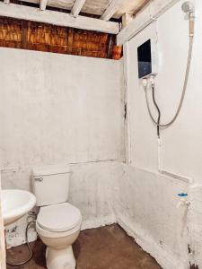 a bathroom with a toilet and a sink at MyLove Siargao Village in General Luna
