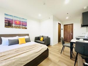 a bedroom with a bed and a chair and a desk at Furnished Rentals at Mangrove Residences Mactan in Punta Engaño