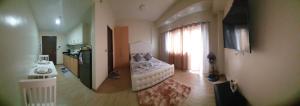 a room with a bedroom with a bed and a kitchen at Megaworld-Manduriao, Iloilo Lafayette in Iloilo City