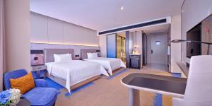 Voodi või voodid majutusasutuse Hampton by Hilton Shenzhen North Station toas